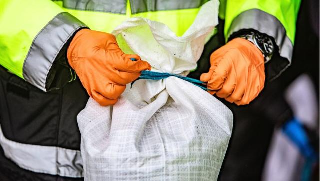 Firefighter tying a sandbag