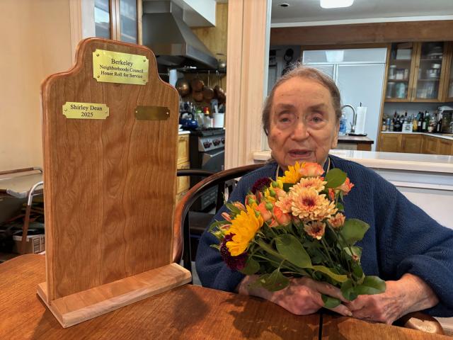 Shirley Dean with the Honor Roll for Service plaque.